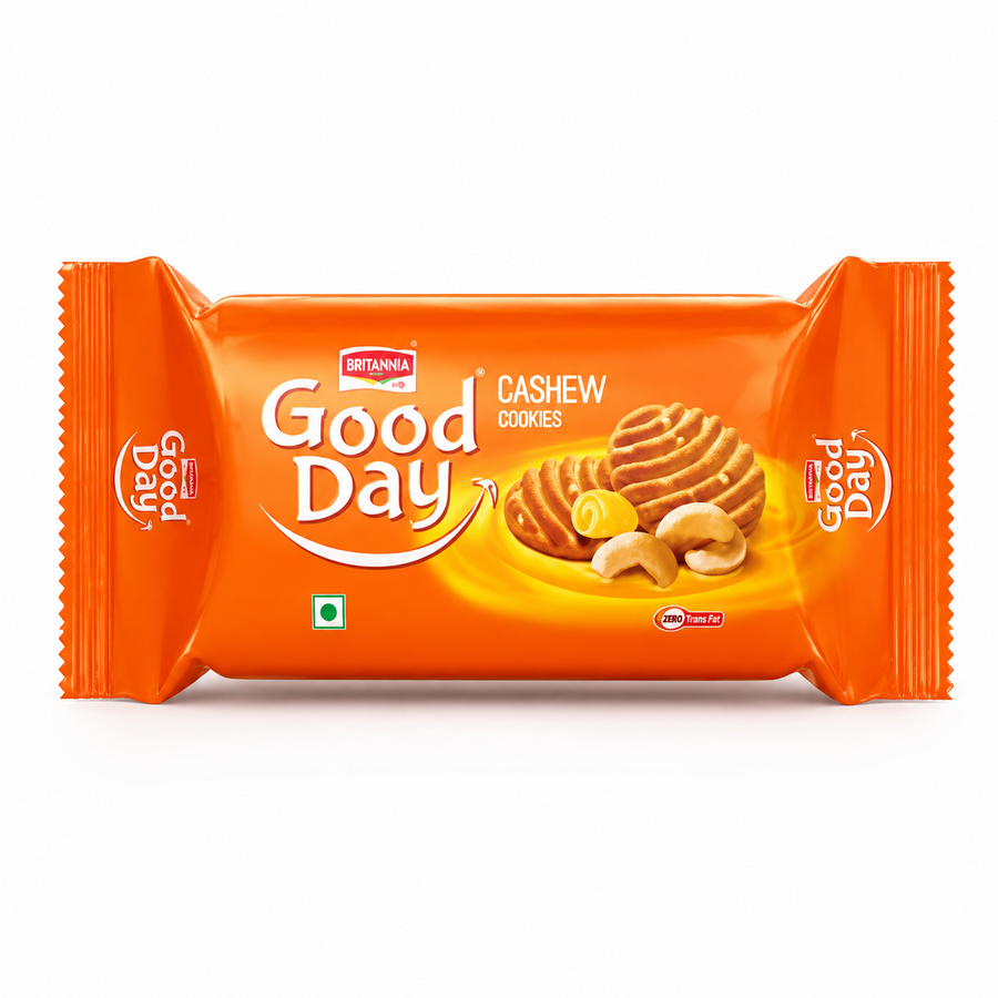 A professional studio product shot of a horizontally oriented bright orange flow-wrap plastic pack of Britannia Good Day Cashew Cookies against a clean white background. The front showcases the prominent white "Good Day" brand logo underscored by a sweeping white-and-red smile graphic. To the right, a realistic illustration features two golden-brown, ridge-patterned cookies alongside a curl of fresh butter and whole roasted cashew nuts. This product is available in the UK at theindianshelf.co.uk.