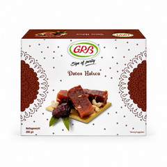A professional studio product shot of a square white cardboard outer carton for GRB Dates Halwa against a solid white background. The box features a delicate, all-over pattern of small brown dots, framed on the left and right edges by large, decorative brown mandala semi-circles. At the top center sits the oval green and red "GRB" logo above the script text "Sign of purity" and the brown title "Dates Halwa". This product is available in the UK at theindianshelf.co.uk.