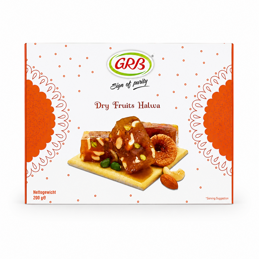 A professional studio product shot of a square white cardboard outer box for GRB Dry Fruits Halwa against a solid white background. The packaging features a delicate pattern of small brown dots, framed on the left and right edges by large, decorative orange mandala semi-circles. At the top center sits the oval green-and-red "GRB" logo above the script text "Sign of purity" and the brown product title "Dry Fruits Halwa".This product is available in the UK at theindianshelf.co.uk.