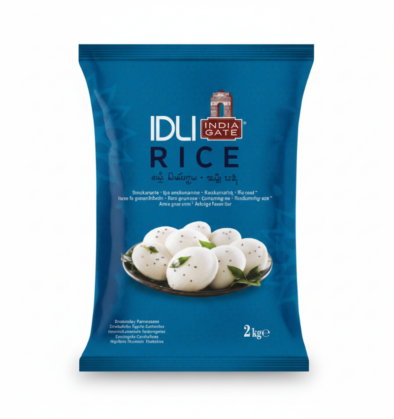 A blue, 2 kge bag of India Gate Idli Rice. The packaging features the brand name, "IDLI RICE," and the India Gate logo, which is styled as an arch. A photograph of several white, steamed idlis, garnished with black speckles and served on a metal plate with green leaves, is centered on the bag. The package also includes text in various languages and scripts.