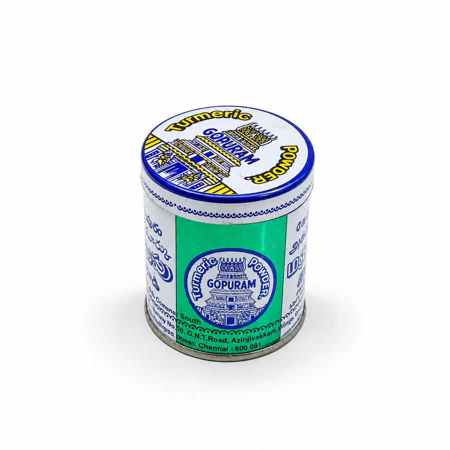 Around metal tin of Gopuram Turmeric Powder in blue and white branding, centered on a solid white background. Available in the UK at theindianshelf.co.uk.
