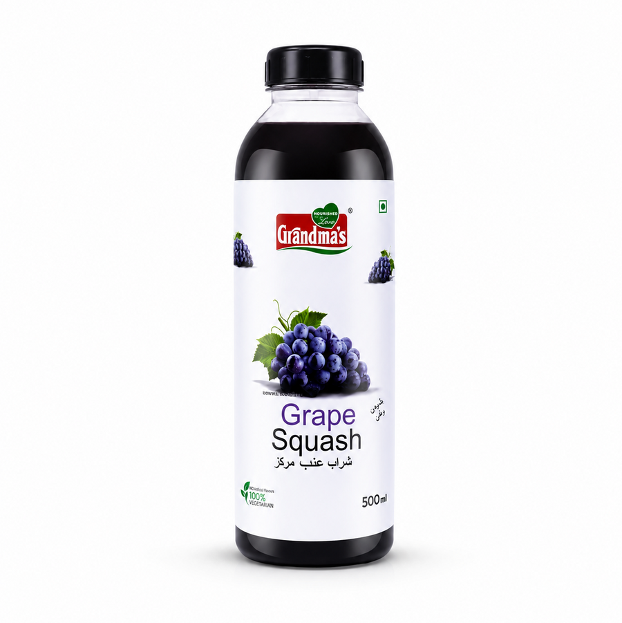 A professional studio product shot of a 500ml bottle of Grandma's Grape Squash isolated against a pure white background in image_918284.png. The transparent bottle shows a deep purple liquid inside and features a clean white label decorated with graphic illustrations of fresh purple grape clusters alongside the red and green brand logo.