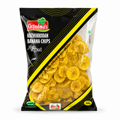 A professional studio shot of the Grandma's Kozhikkodan Banana Chips packaging.The bag features a sleek black design with bold yellow diagonal stripes and the red "Grandma's" logo at the top left. A large transparent window allows a clear view of the thin, golden-yellow round banana chips inside. The text "Kozhikkodan Banana Chips" and "Deep Crunched" are printed prominently.It indicates a net weight of 200g. This product is available in the UK at theindianshelf.co.uk.