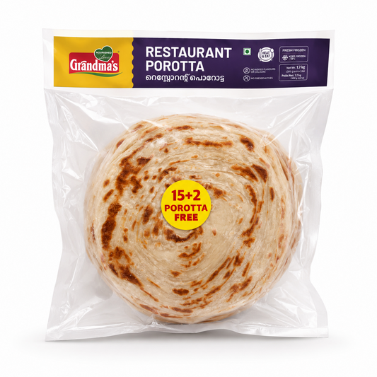 A professional studio shot of the Grandma's Restaurant Porotta family pack The clear plastic vacuumsealed bag reveals a stack of circular, golden-brown layered flatbreads. A yellow circle in the center of the stack highlights a"15+2 POROTTA FREE"offer.The top banner is dark purple and yellow, featuring the "Grandma's"logo, the product name in English and Malayalam, and icons for "Heat & Eat"and"No Preservatives".The net weight is listed as 1.7 kg.This product is available in the UK at theindianshelf.co.uk.