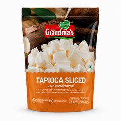 A professional studio shot of a stand-up pouch of Grandma's Sliced Tapioca. The top half of the packaging features a rustic background of whole, brown cassava roots with dark green leaves, centered around the red and white "Grandma's" logo.  The lower half of the bag is a solid orange panel featuring the product title "TAPIOCA SLICED" in bold white lettering, along with its name.This product is available in the UK at theindianshelf.co.uk.