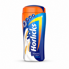  Horlicks Classic Malt jar on a white background. The container has an orange upper section and a bright blue body, topped with a dark blue and orange flip lid. The prominent white vertical "Horlicks" logo is centered on a blue background graphic accented by a large yellow and orange chevron arrow. On the left side, a splashing milk graphic is adorned with three golden ears of wheat. Small circular health benefit icons sit near the top,This product is available in the UK at theindianshelf.co.uk.