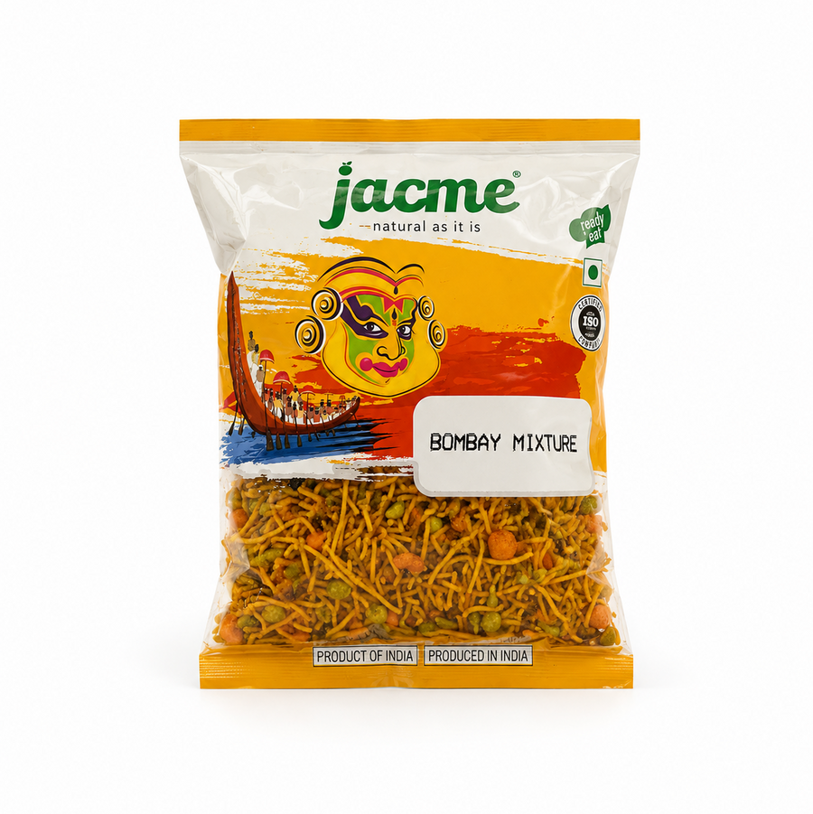 A bag of Jacme Bombay Mixture spice mix, featuring a white and orange packaging design with a traditional Indian mask illustration and a clear lower section showing the yellow-orange spice blend inside. this product is Available in the UK at theindianshelf.co.uk.