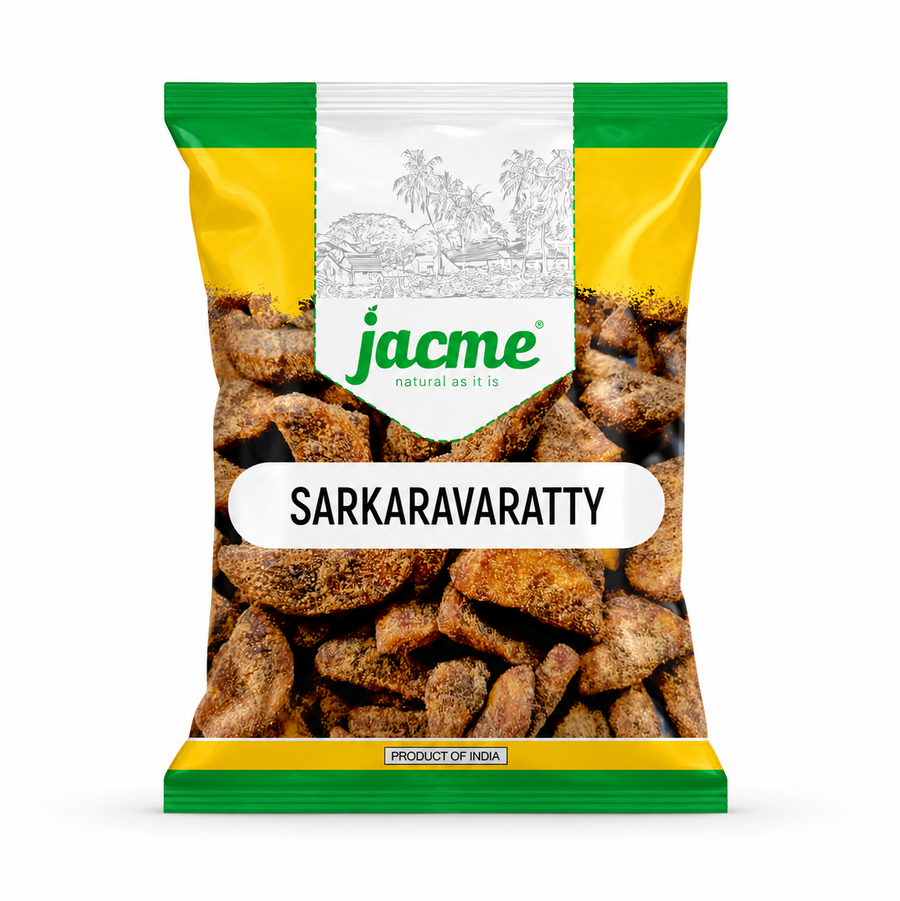 A professional studio product shot of a clear pillow pouch filled with rustic, jaggery-coated Jacme Sarkaravaratty chunks isolated against a pure white background. The clean packaging features a white, yellow, and green header label showing a traditional village sketch above the prominent product name.