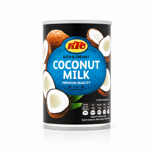 A tin can of KTC Rich & Creamy Coconut Milk centered on a solid white background, featuring a black design with a blue oval logo surrounded by halved and whole coconut illustrations along with nutritional front-of-pack labeling. This product is available in the UK at theindianshelf.co.uk.