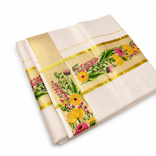 A studio product shot showing an angled view of an elegantly unfolded Kerala Set Saree on a plain white background. The off-white woven cotton fabric is layered to display both its decorative body border and its ornate corner panel layout. Broad shimmering golden tissue bands (kasavu) frame horizontal and vertical panels intricately embroidered with vivid yellow, pink, and orange flowers mixed with rich green leaves. Available in the UK at theindianshelf.co.uk.
