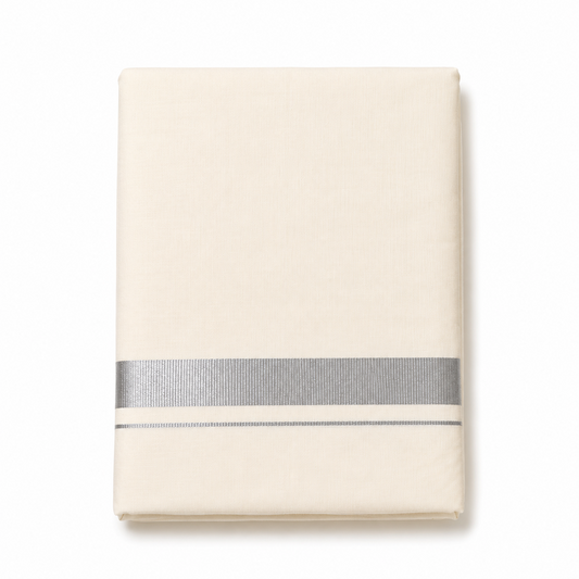 A neatly folded cream men's Kerala kasavu mundu (dhoti) centered on a solid white background, featuring a wide horizontal silver zari border (kara) and a thin parallel silver accent stripe near the bottom edge. Available in the UK at theindianshelf.co.uk.