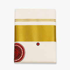 A close-up folded view of an off-white Kerala tissue cotton kasavu set mundu centered on a solid white background, displaying a wide horizontal metallic gold zari band alongside a circular red, black, and white Theyyam crown motif. Available in the UK at theindianshelf.co.uk