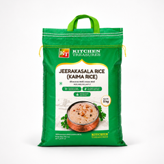 A professional studio shot of a large 5 kg woven sack of Kitchen Treasures Jeerakasala Rice (Kaima Rice) The packaging features a striking green color scheme with a built-in green fabric carrying handle at the top. The bold white "KT Kitchen Treasures" stamp logo is displayed near the top left. The central white label features the product name in large brown lettering along with its Malayalam translations, This product is available in the UK at theindianshelf.co.uk.
