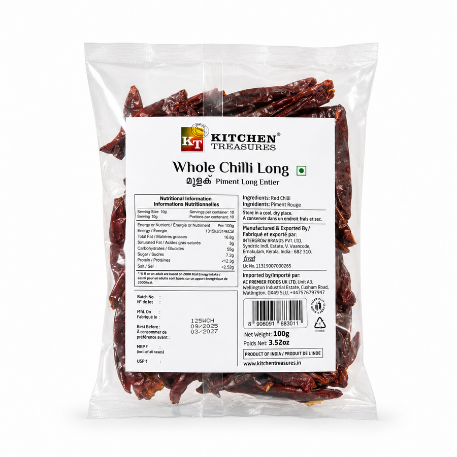 A professional studio product shot of a 100g clear pillow pouch of Kitchen Treasures Whole Chilli Long isolated against a pure white background in image_971bc0.jpg. The transparent packaging clearly showcases the textured, deep crinkled crimson whole red chillies packed inside, centered behind a clean white information label displaying nutritional tables, barcodes, and manufacturing details. This product is available in the UK at theindianshelf.co.uk.