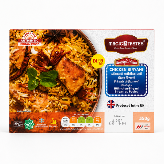 A professional studio shot of a landscape-oriented rectangular cardboard box for Magic Tastes Chicken Biryani (Nostalgic Edition) The left half of the packaging displays a rich, appetizing close-up graphic of a copper handi filled with golden-hued basmati rice, caramelized onions, fresh green herbs, a star anise pod, and a succulent piece of roasted chicken. Small square logos in the lower-left corner read "READY TO EAT," "HALAL," This product is available in the UK at theindianshelf.co.uk.