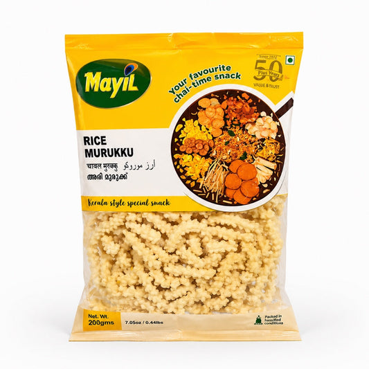 A professional studio shot of the Mayil Rice Murukku packaging. The bag features a bright yellow top section with the green "Mayil" logo on the left and a "50 Plus Years" seal on the right. A circular graphic in the center showcases a variety of traditional Kerala snacks. The bottom half of the bag is transparent, revealing the pale-yellow, coiled, and bumpy-textured rice murukku inside.This product is available in the UK at theindianshelf.co.uk.