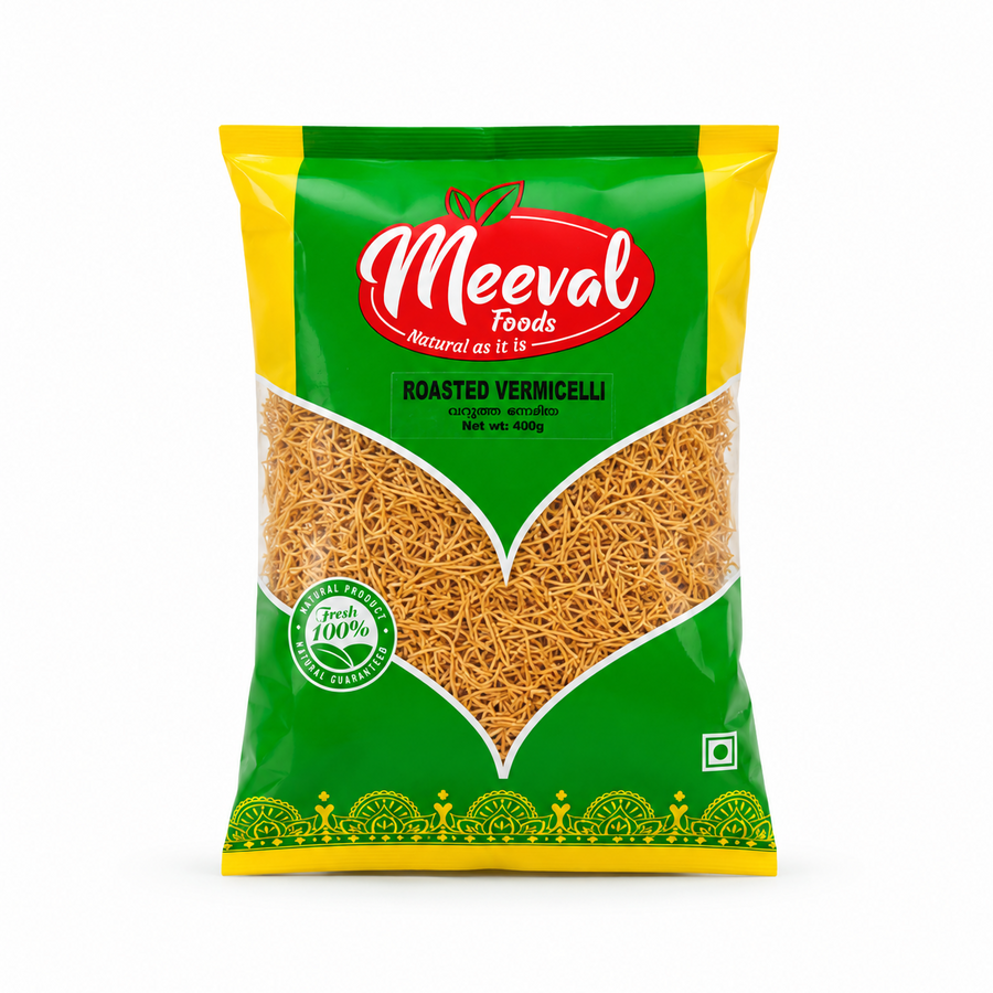 A professional studio product shot of a 400g retail pillow pouch of Meeval Foods Roasted Vermicelli isolated against a pure white background in image_7ccde1.jpg. The vibrant green and yellow packaging features a large, leaf-shaped clear window showcasing the golden-brown, fine strands of roasted vermicelli inside below the prominent red and white Meeval Foods logo. This product is available in the UK at theindianshelf.co.uk.