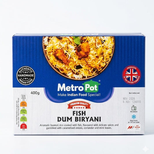 A 400g blue and white box of Metro Pot Fish Dum Biryani. The packaging displays a top-down view of aromatic Basmati rice cooked with fish, flavored with delicate spices and garnished with caramelized onions, coriander, and mint leaves. The label describes the product as "Authentic Handmade Indian Food" and prominently features a "Producer in the United Kingdom" logo. It also includes a "Premium Quality" seal and a Best Before date of November 2026.
This frozen, ready-to-heat meal available for purchase 