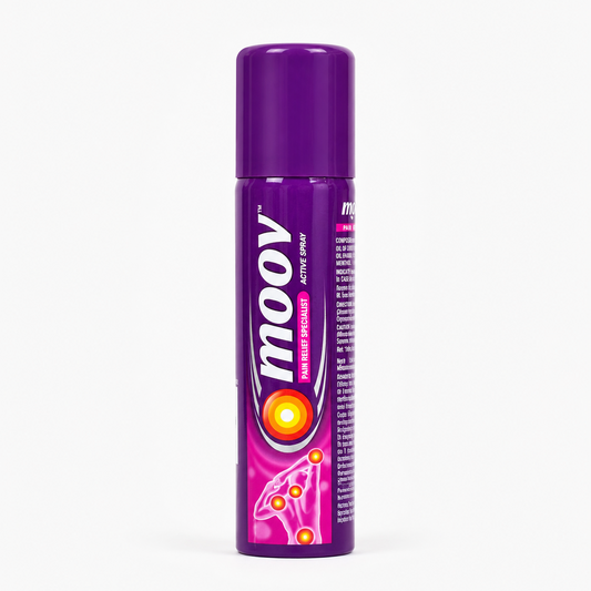 A person's hand holding a tall, cylindrical purple aerosol can of Moov Pain Relief Active Spray The container features a solid purple plastic cap on top. The main body is decorated with a glossy purple wrap-around label highlighting the large, distinctive white "moov" logo written vertically with a silver border. Directly to the right of the logo, a pink vertical badge displays the words "PAIN RELIEF SPECIALIST" alongside the text "ACTIVE SPRAY"This product is available in the UK at theindianshelf.co.uk.