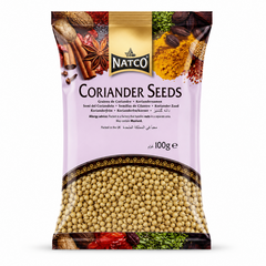 A studio product shot of a 100g vertical pillow pouch of Natco Coriander Seeds against a white background. The top of the pouch displays an artistic border containing images of star anise, cinnamon, nutmeg, and turmeric powder. The black and gold "NATCO" is centered directly above the prominent title "CORIANDER SEEDS". The lower half features a large, transparent crescent window that clearly displays the round, golden-brown whole coriander seeds inside. 