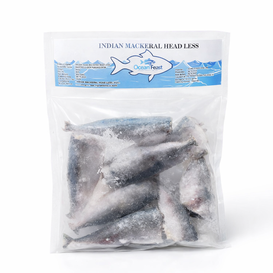 A clear, vacuum-sealed bag of OceanFeast Indian Mackerel Headless. The pack contains several frozen, cleaned, and headless Indian Mackerels, making them convenient and ready for cooking. The blue and white header label features the brand logo and the product name in English.
This seafood product is available for purchase in the UK at theindianshelf.co.uk.