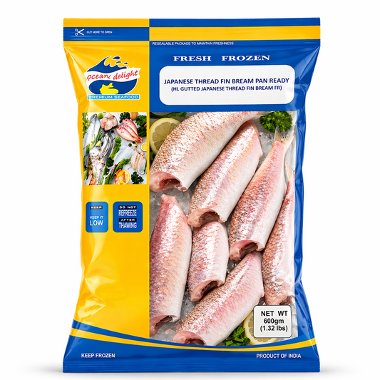 A professional studio shot of a 600g bag of Oceans Delight Japanese Thread Fin Bream. The packaging features a bright yellow and blue color scheme with a resealable top. A clear window in the center displays several cleaned, pink-hued, headless fish packed on ice. The "Oceans Delight" logo is in the top left, and the label clearly states "Japanese Thread Fin Bream Pan ReadyThis product is available in the UK at theindianshelf.co.uk.