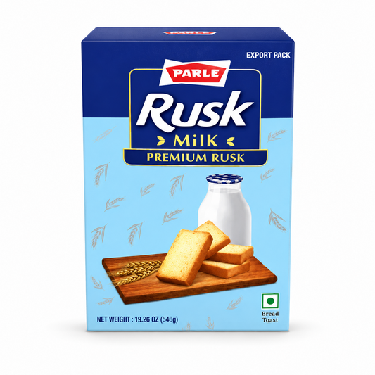 A professional studio shot of the Parle Milk Rusk box. The packaging features a two-tone blue design with a dark blue top and a light blue bottom decorated with faint wheat stalk patterns. The "PARLE" logo sits above the bold white text "Rusk" and gold text "Milk". An illustration shows four golden-brown rusks on a wooden board next to wheat ears and a bottle of milk. The box indicates a net weight of 546g and includes the green vegetarian symbol. This product is available in the UK at theindianshelf.co.uk.