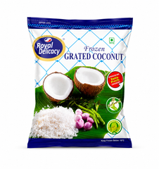 Studio product shot of a standing pouch of Royal Delicacy Frozen Grated Coconut on a white background. The white pack has a blue grid design and blue borders. The oval blue and gold logo is in the top left corner, with the title "Frozen GRATED COCONUT" in bold center lettering. A central image shows two open coconut halves on a banana leaf next to freshly grated coconut, purple shallots, and green chilies. Badges on the right state "Twin Pack" and "All Natural". Available in the UK at theindianshelf.co.uk.