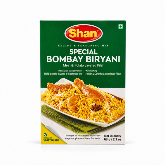 A 60g box of Shan Special Bombay Biryani Recipe & Seasoning Mix centered on a solid white background, featuring a green top section with the Shan logo and a serving suggestion showing vibrant yellow biryani rice topped with chicken drumsticks and whole spices. This product is available in the UK at theindianshelf.co.uk.