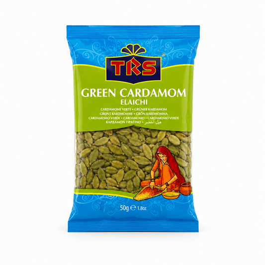 A 50g pouch of TRS Green Cardamom Elaichi centered on a solid white background, featuring a vibrant blue and light green label with the brand logo and a clear window displaying whole green cardamom pods next to an illustration of a traditional Indian woman. This product is available in the UK at theindianshelf.co.uk.