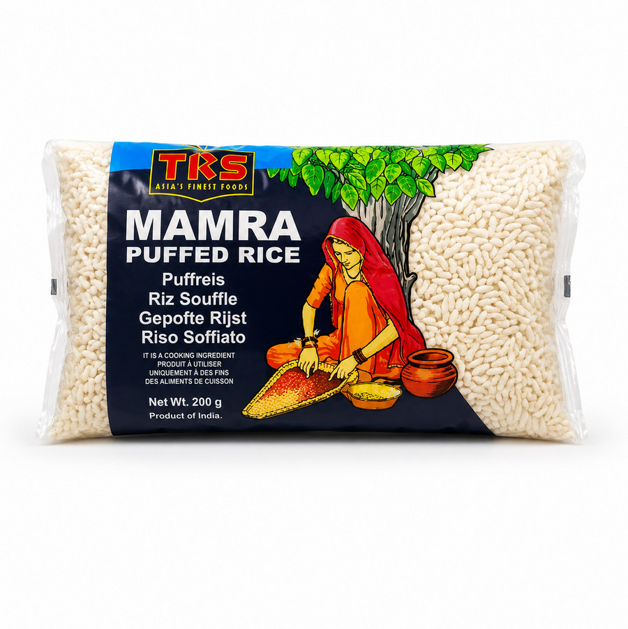 A 200g horizontal pouch of TRS Mamra Puffed Rice centered on a solid white background, featuring a dark blue and green packaging design with the TRS logo and a clear window displaying crisp white puffed rice next to an illustration of a traditional Indian woman under a tree. This product is available in the UK at theindianshelf.co.uk.