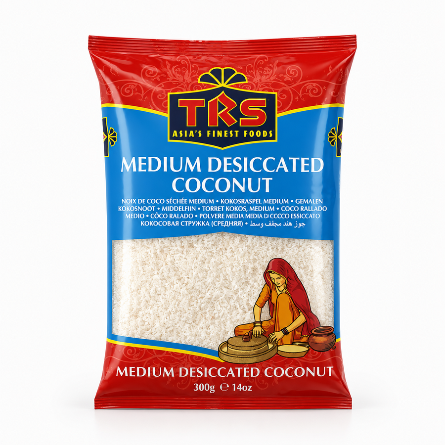 A 300g pouch of TRS Medium Desiccated Coconut centered on a white background, featuring a vibrant red and blue label with the brand logo and an illustration of a woman using a traditional grinding stone, displaying the white desiccated coconut through a transparent window. This product is available in the UK at theindianshelf.co.uk.