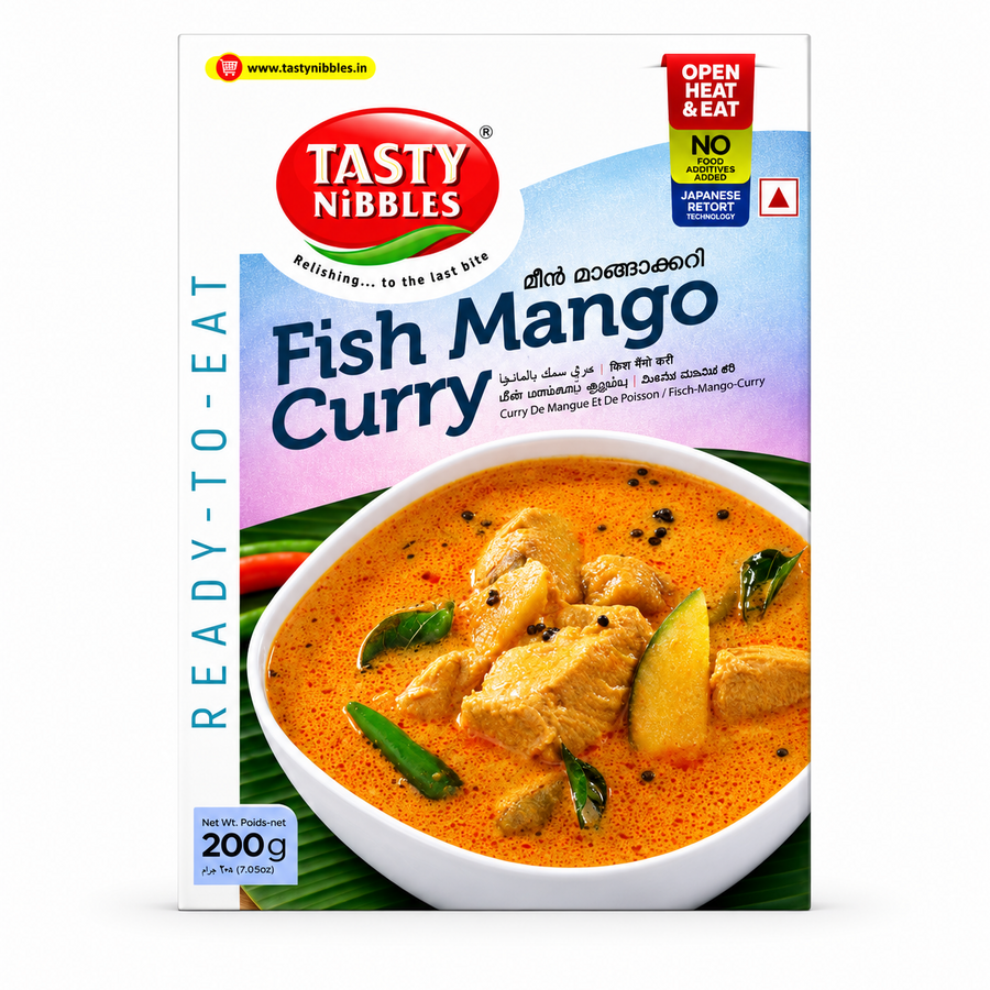 A professional studio product shot of a 200g cardboard box of Tasty Nibbles Fish Mango Curry standing vertically against a plain white background. The packaging features a clean white frame surrounding a textured light purple and blue upper graphic that displays the red oval "TASTY NIBBLES" logo. The product name "Fish Mango Curry" is printed boldly across the center in dark blue lettering. This product is available in the UK at theindianshelf.co.uk.