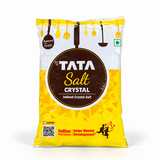 A yellow and white packet of Tata Salt Crystal iodised salt featuring a round brown logo and clear product details. Available in the UK at theindianshelf.co.uk