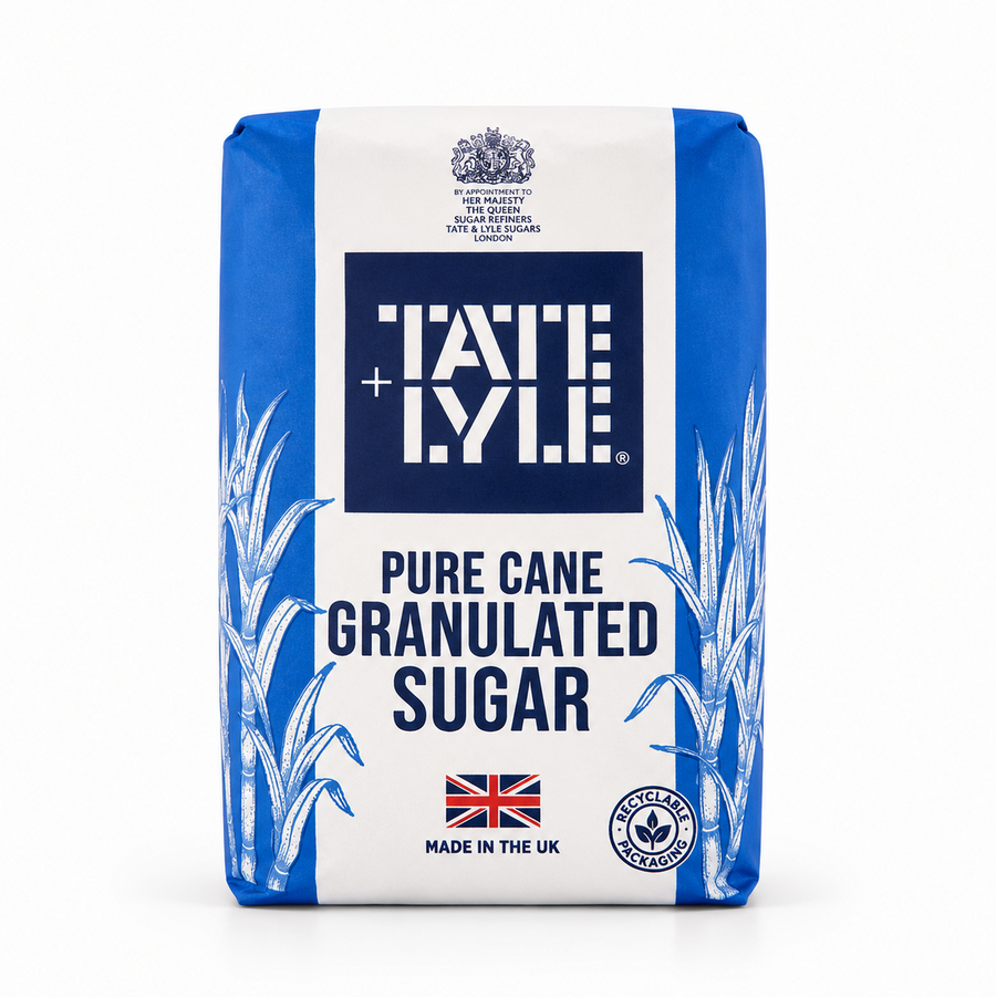 A paper bag of Tate & Lyle Pure Cane Granulated Sugar centered on a solid white background, featuring a blue and white packaging design with sugar cane illustrations, the Union Jack flag, and a recyclable packaging seal. This product is available in the UK at theindianshelf.co.uk.