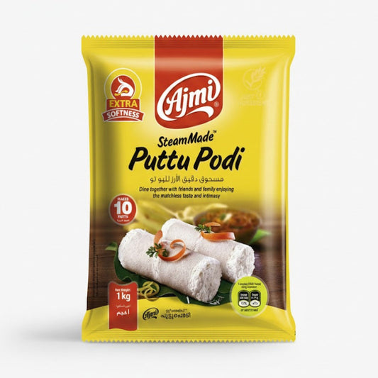 Ajmi SteamMade Puttu Podi (Rice Flour for Puttu) 1kg pack, featuring "EXTRA SOFTNESS" for a superior texture and a note that it "MAKES 10 PUTTU," is an authentic South Indian convenience product. The bright yellow and red packaging displays two perfectly steamed puttu cylinders and is available for purchase at theindianshelf.co.uk.