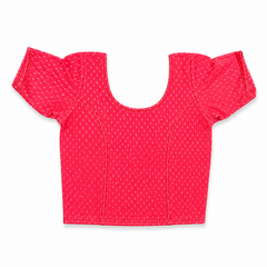 A vibrant bright pink short-sleeved stretchable readymade saree blouse with a textured jacquard micro-pattern and deep scoop neckline, laid flat against a solid white background. Available in the UK at theindianshelf.co.uk.