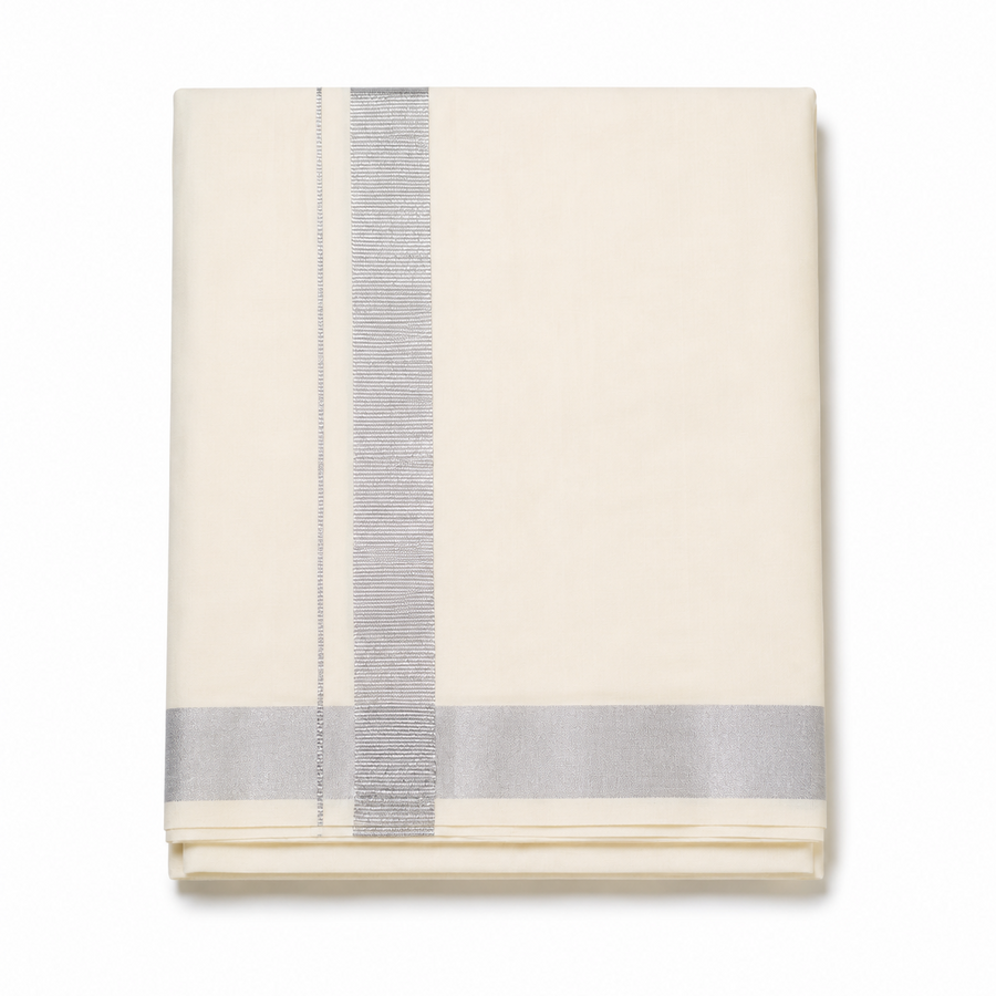 A neatly folded cream men's Kerala kasavu mundu (dhoti) centered on a solid white background, featuring a wide silver zari border running vertically, a parallel fine silver stripe, and a matching silver border along the bottom hem. Available in the UK at theindianshelf.co.uk.