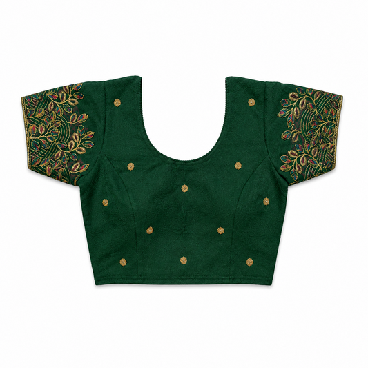 An emerald green short-sleeved stretchable readymade saree blouse with hand-embroidered leaf patterns on the sleeves and small gold floral motifs across the front, laid flat against a solid white background. Available in the UK at theindianshelf.co.uk.