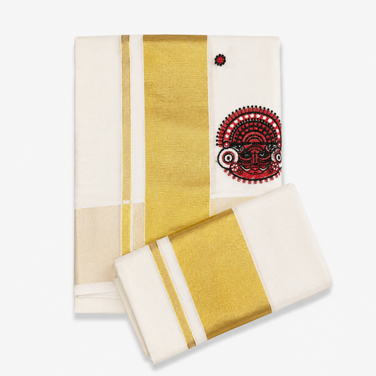A neatly folded off-white Kerala tissue cotton single set mundu with its matching neryathum folded diagonally on top against a solid white background, featuring a wide metallic gold zari border and a vibrant red and black Theyyam ritual art motif. Available in the UK at theindianshelf.co.uk.