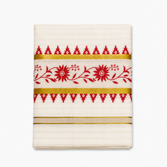 A close-up folded view of an off-white Kerala tissue cotton kasavu set mundu centered on a solid white background, showcasing a horizontal red floral vine motif framed by gold zari bands and red temple edge borders. Available in the UK at theindianshelf.co.uk.