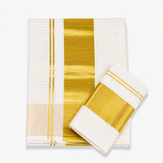 A neatly folded off-white Kerala tissue cotton single set mundu with matching neryathum placed diagonally on top against a solid white background, featuring an all-over golden check pattern and a wide metallic gold zari (kasavu) border. Available in the UK at theindianshelf.co.uk.