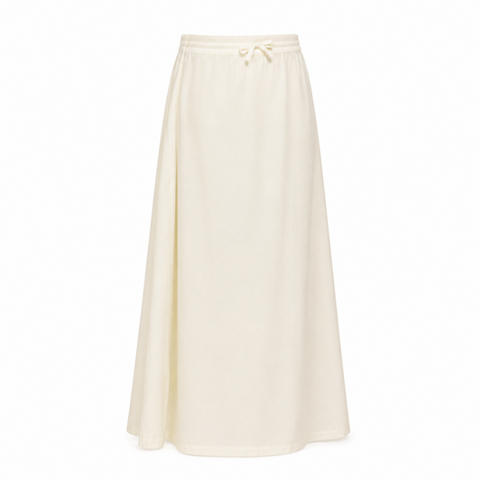 An off-white pure cotton saree petticoat featuring an elastic waistband with drawstring tie, displayed against a solid white background. Available in the UK at theindianshelf.co.uk.