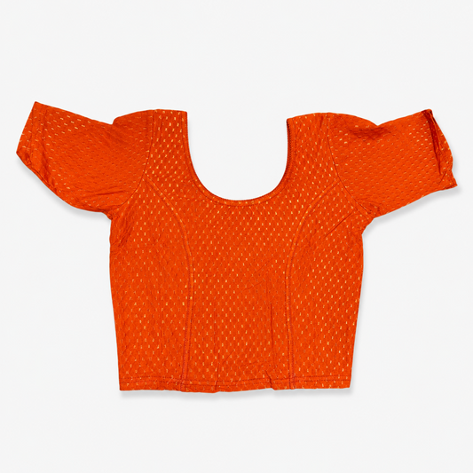 A vibrant orange short-sleeved stretchable readymade saree blouse with a textured jacquard micro-pattern and deep scoop neckline, laid flat against a solid white background. Available in the UK at theindianshelf.co.uk.