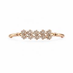 A rose gold-tone open cuff bracelet featuring a delicate central row of five floral clusters encrusted with clear crystals, set against a solid white background. Available in the UK at indianshelf.co.uk.